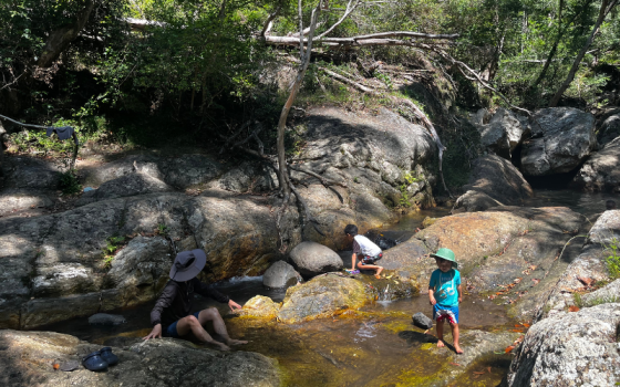 cedar creek rockpool at thunderbird park with children playing in shallow water