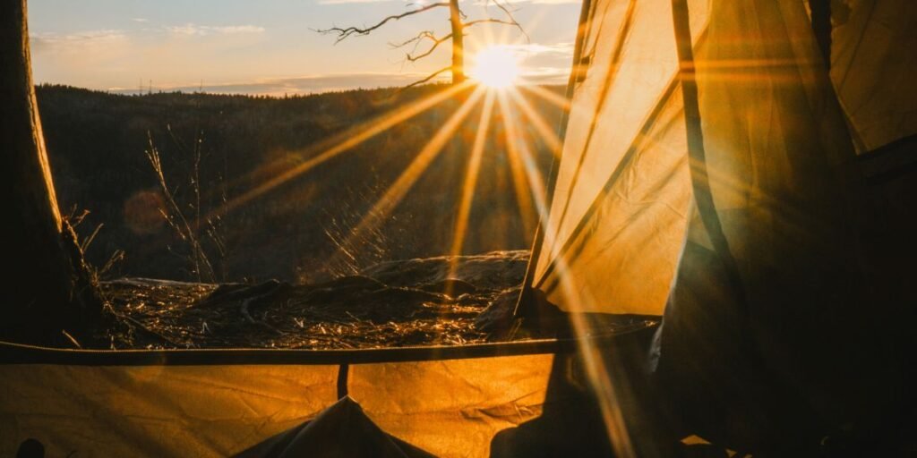 Early morning sunshine comes into a family camping tent